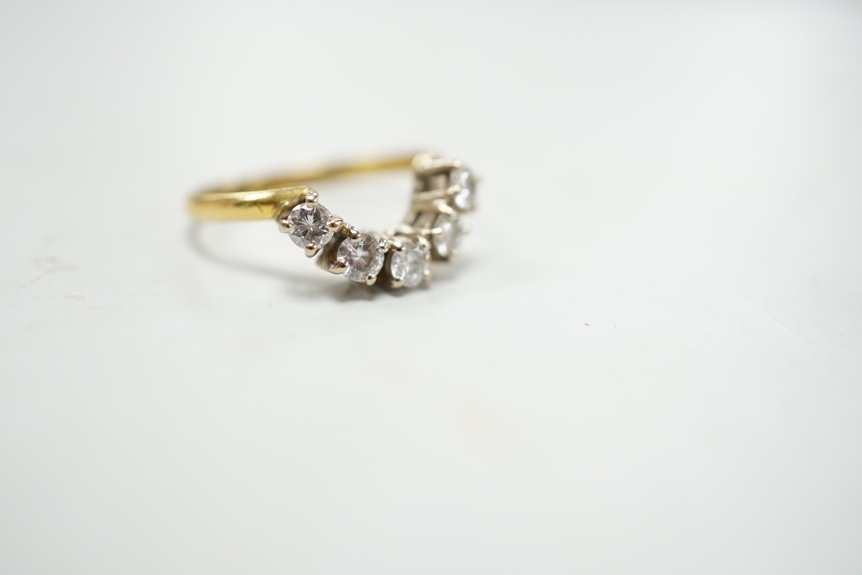 A modern 18ct gold and five stone diamond set demi-lune ring (part of a wedding set?) size M, gross 2.9 grams.